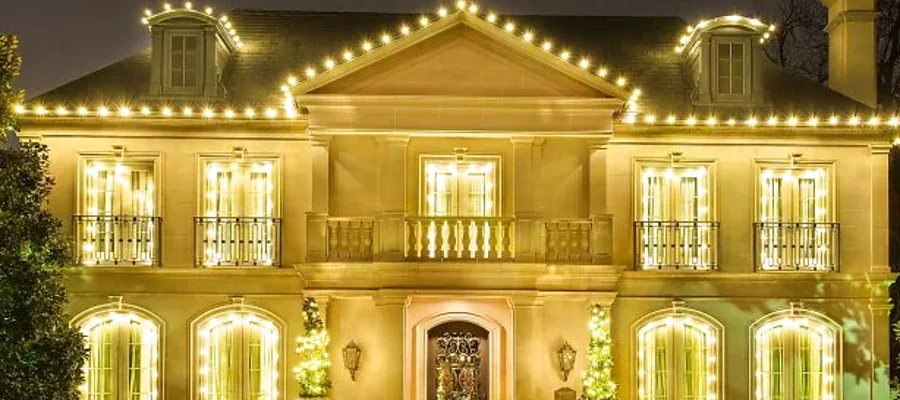 Close-up of evenly spaced warm white bulbs along a roof edge and column